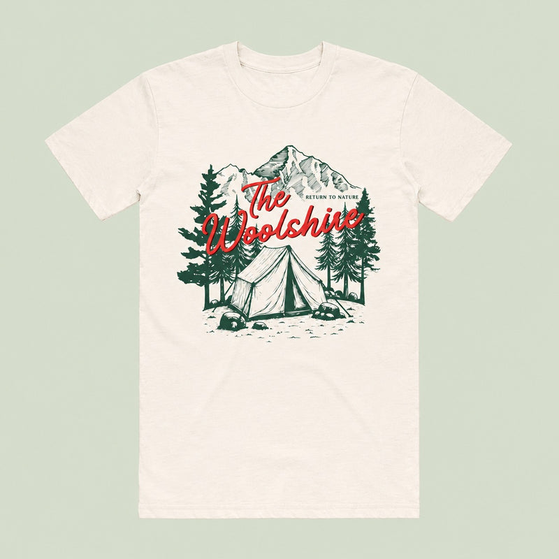 The Woolshire organic cotton t-shirt in natural, with a mountain campsite print and the Woolshire name in red script