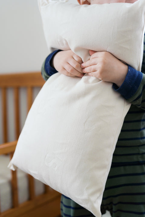 Wool toddler pillow with organic cotton shell standing upright